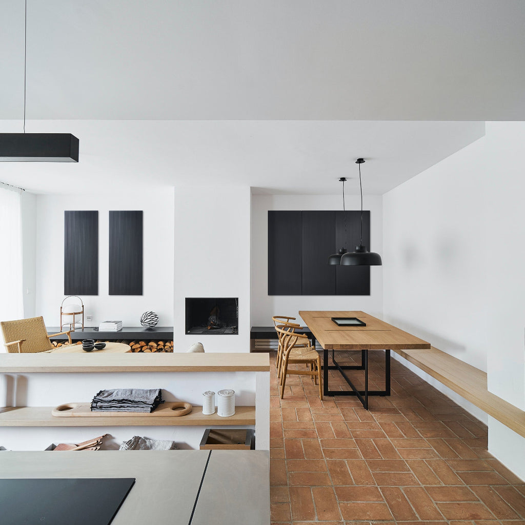 Kitchen with black acoustic wall panels in steel from DAMPA. Hanging over the zink and dinner place 